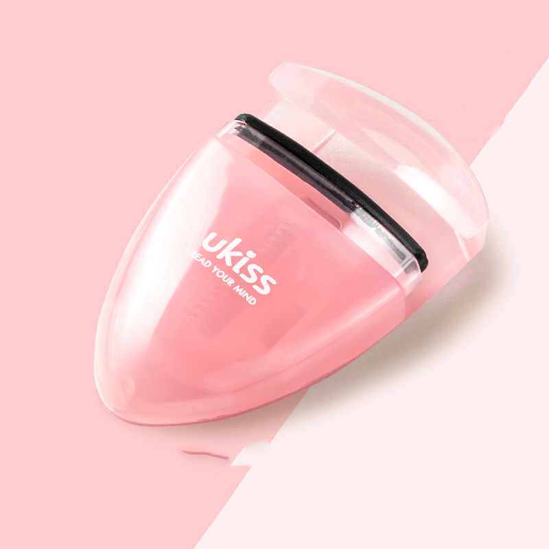 Mini portable eyelash curler.