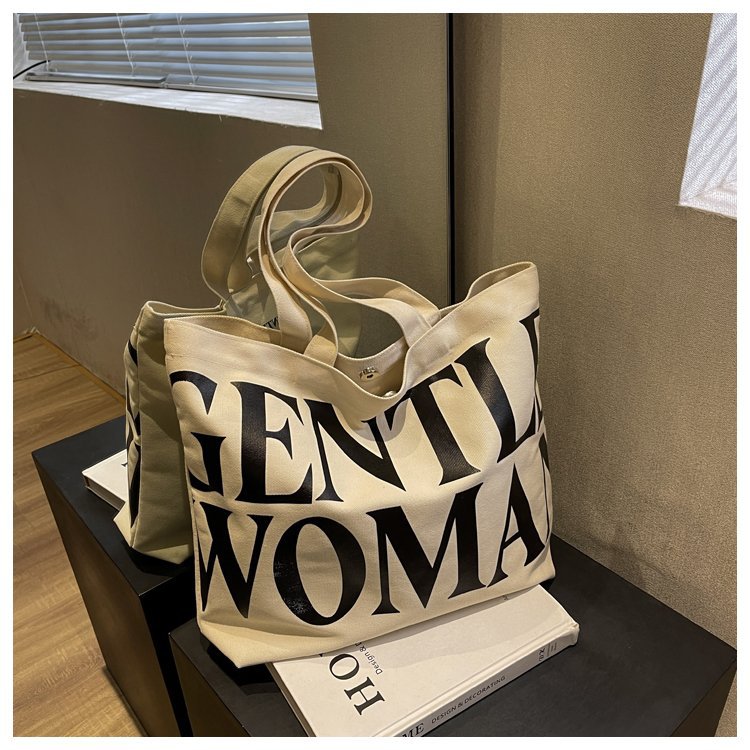 Gentlewomen Tote Bag - A spacious canvas bag with a stylish letter print, perfect for travel, casual outings, and everyday shopping.