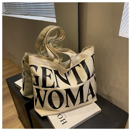 Gentlewomen Tote Bag - A spacious canvas bag with a stylish letter print, perfect for travel, casual outings, and everyday shopping.
