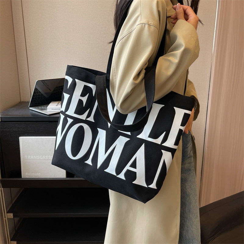 Gentlewomen Tote Bag - A spacious canvas bag with a stylish letter print, perfect for travel, casual outings, and everyday shopping.